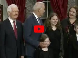 Joe Biden strokes the face of a young girl someone's daughter during photo ceremony